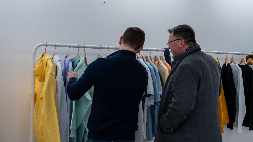 Two customers look at summer hoodie range